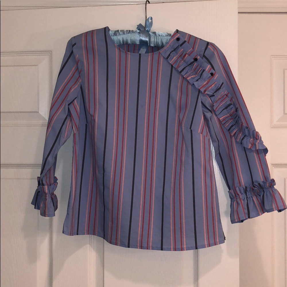 Cute striped blouse with ruffle and buttons.